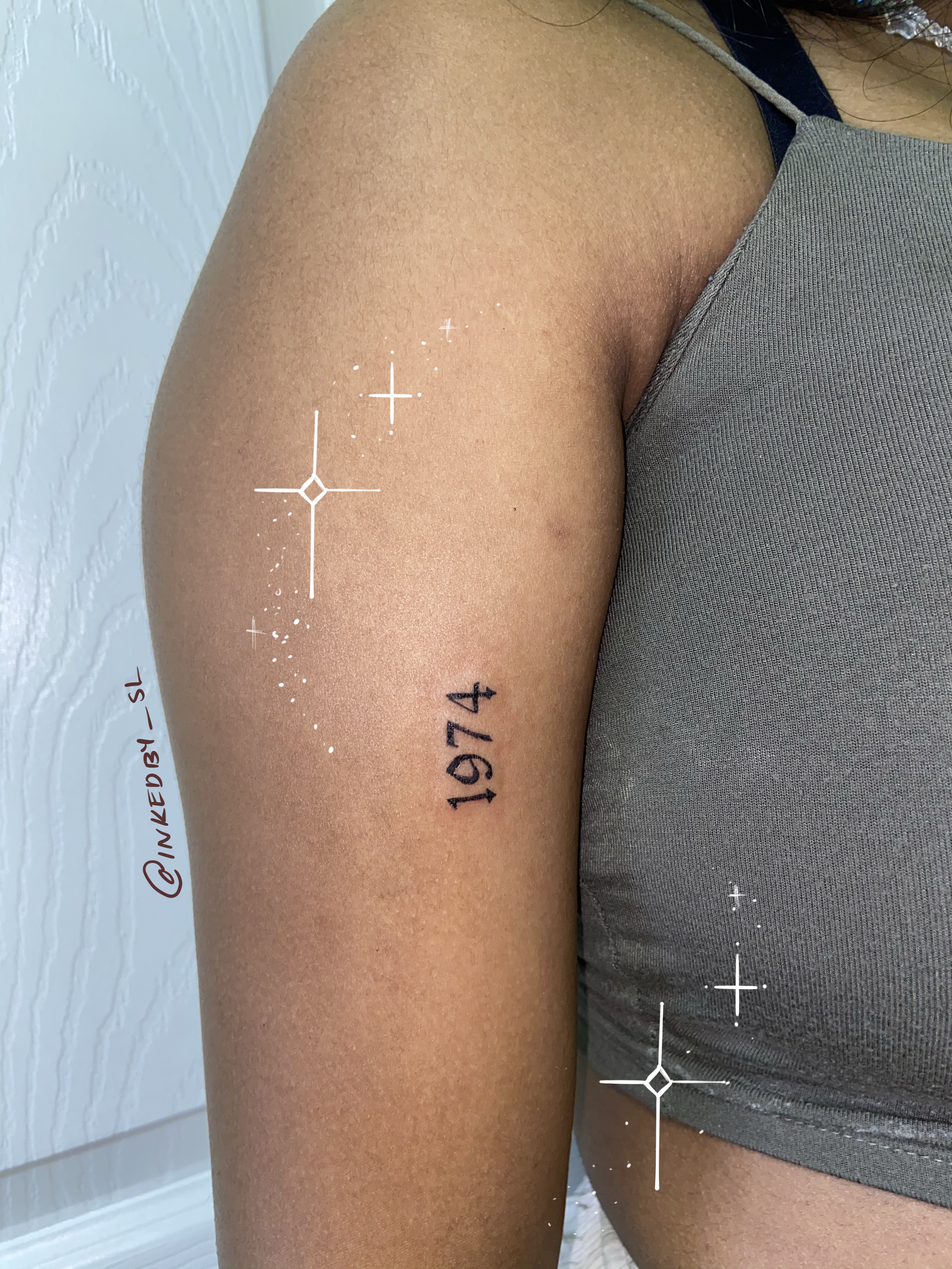 A client showing off the tattoos they received from Inked by SL.