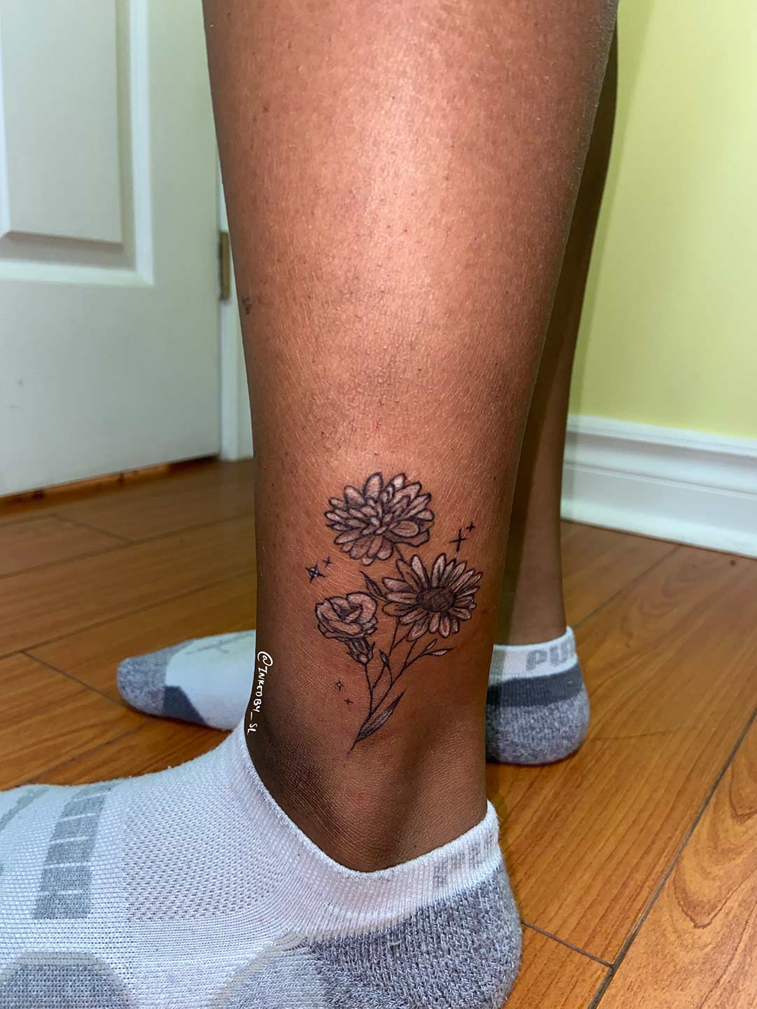 A client showing off the tattoos they received from Inked by SL.