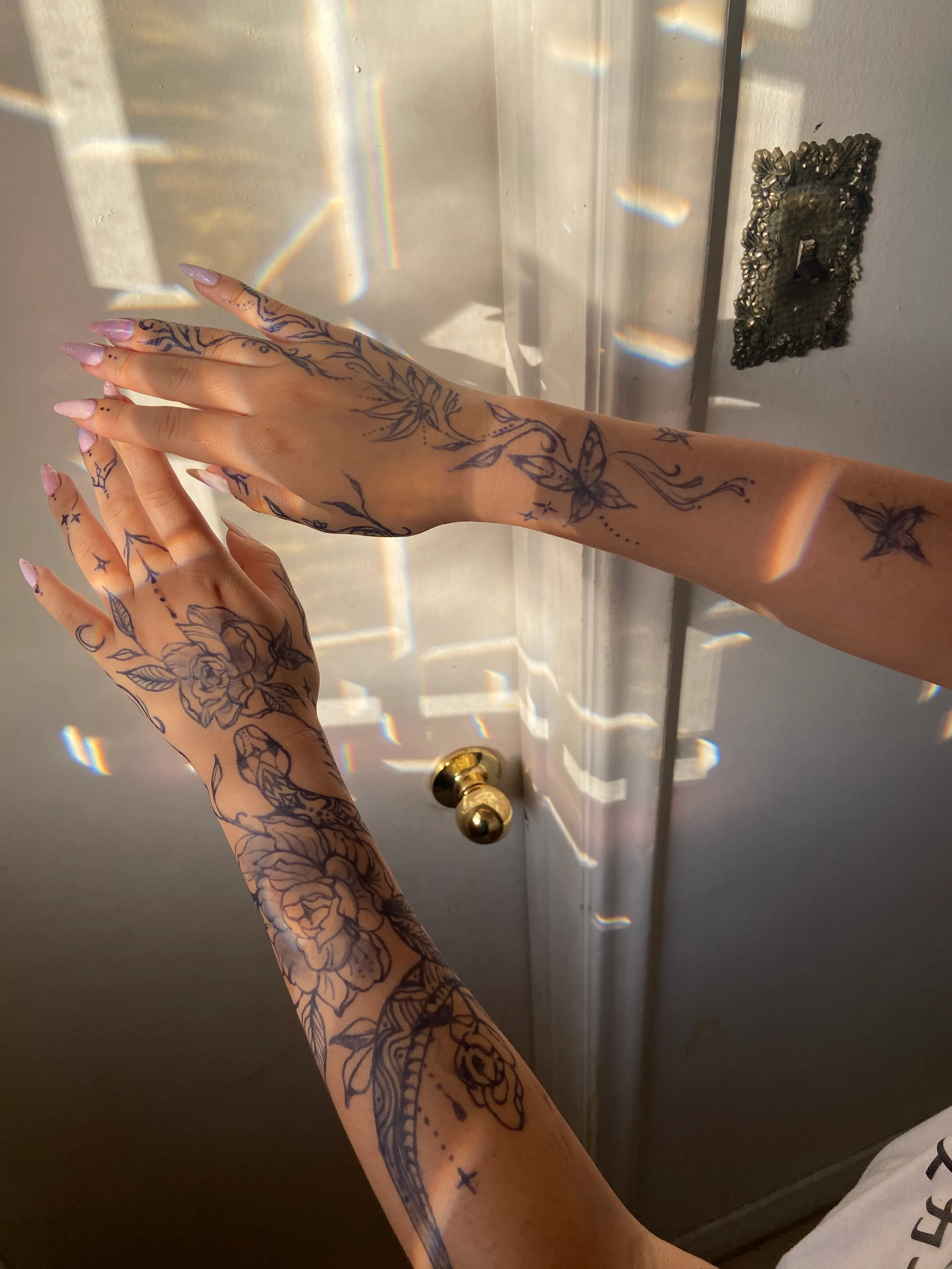 A client showing off the tattoos they received from Inked by SL.