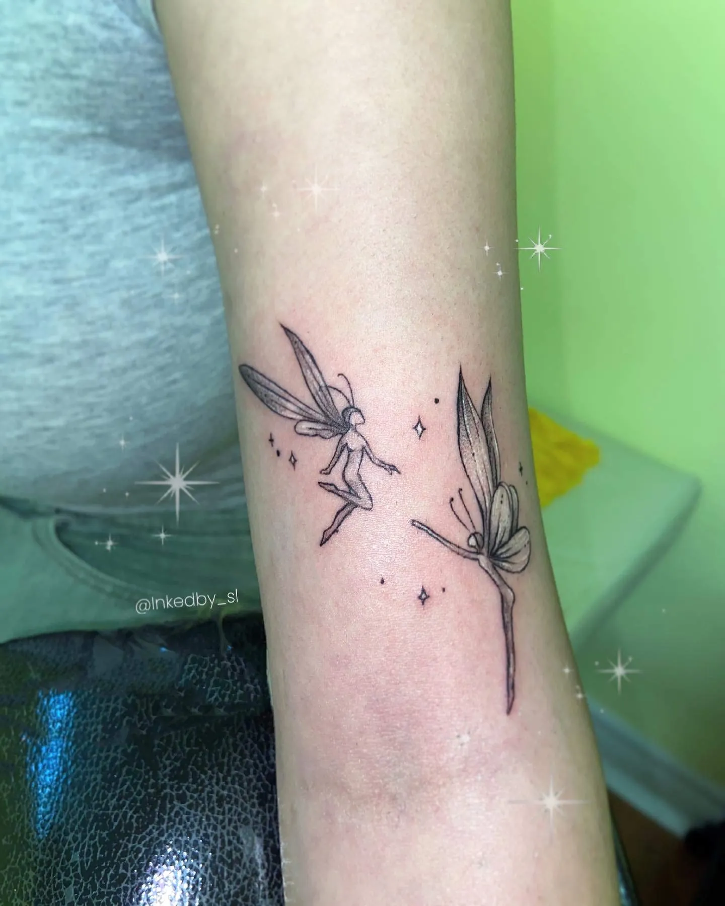 A client showing off the tattoos they received from Inked by SL.