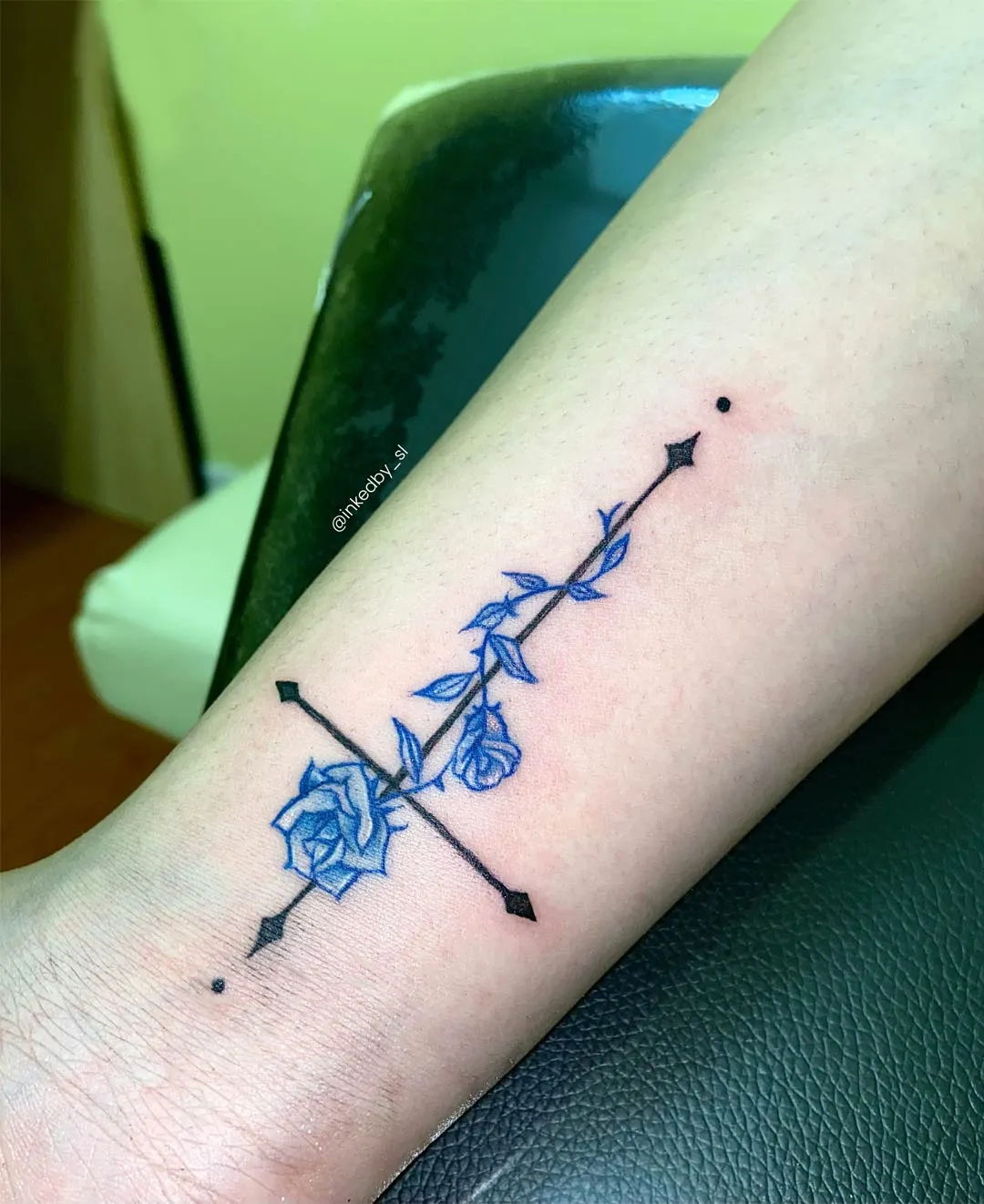 A client showing off the tattoos they received from Inked by SL.