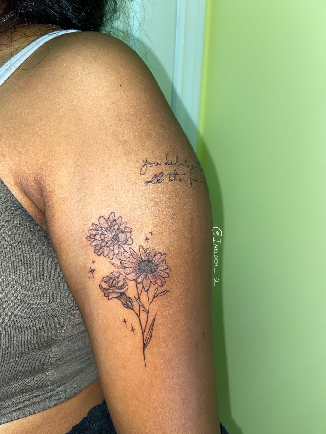 A client showing off the tattoos they received from Inked by SL.