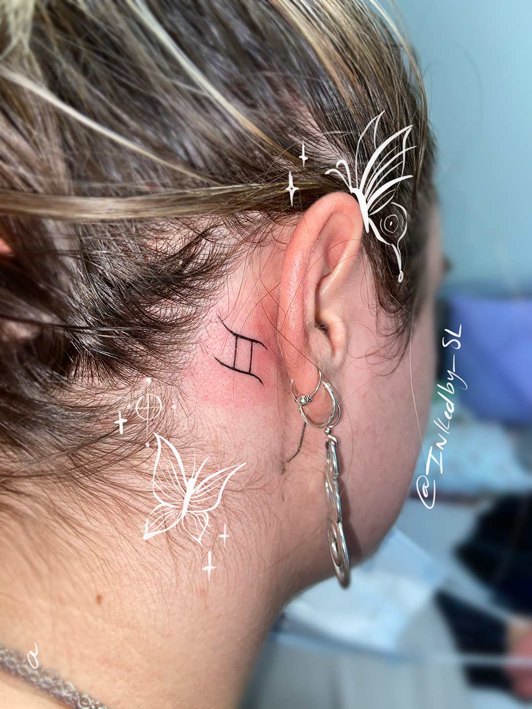 A client showing off the tattoos they received from Inked by SL.