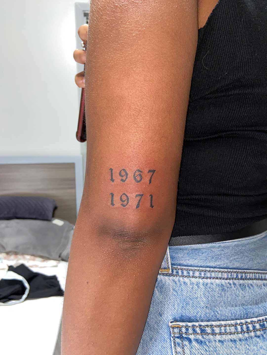 A client showing off the tattoos they received from Inked by SL.