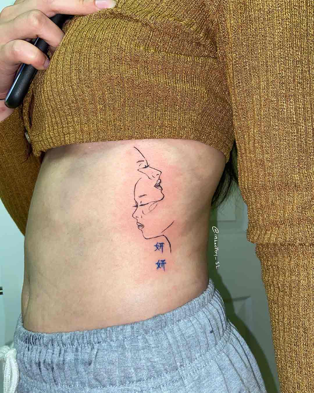 A client showing off the tattoos they received from Inked by SL.