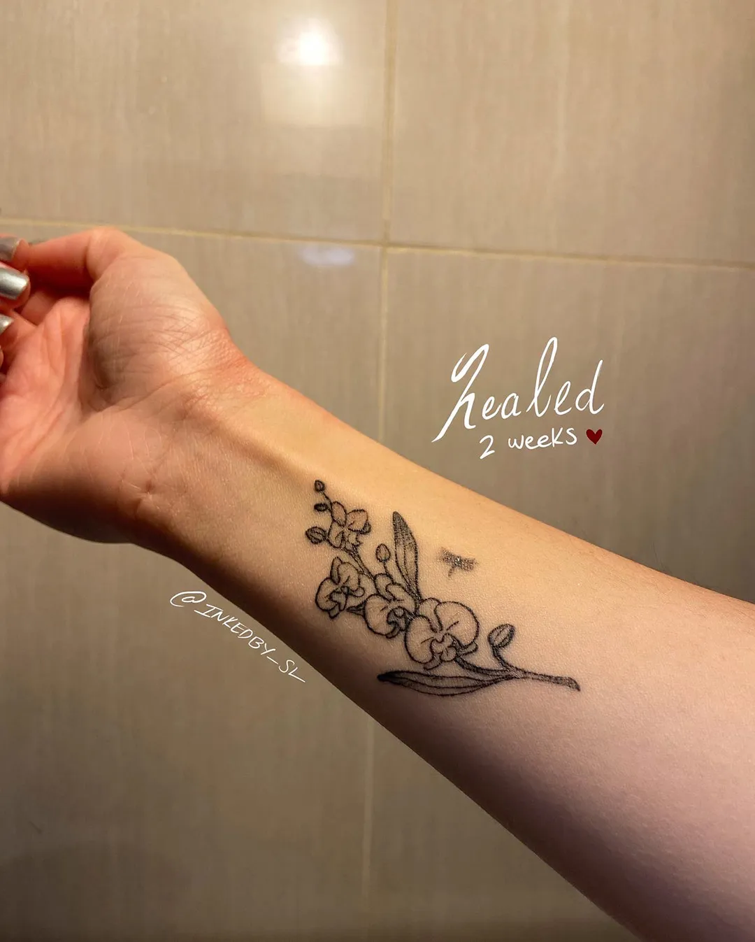 A client showing off the tattoos they received from Inked by SL.