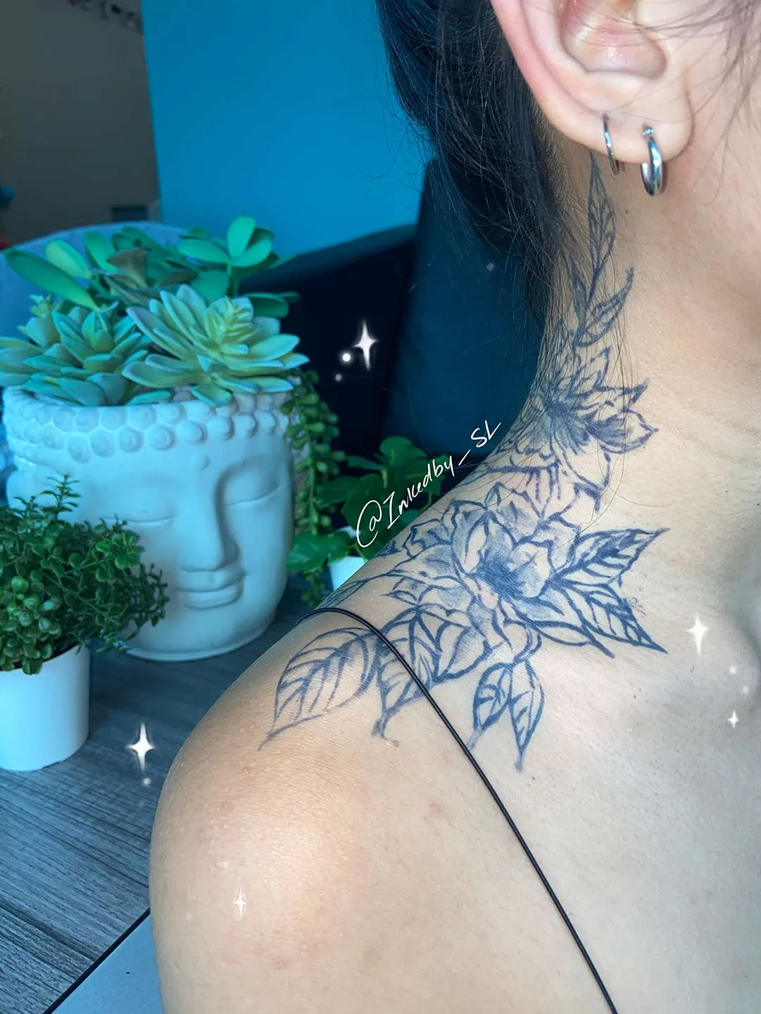 A client showing off the tattoos they received from Inked by SL.