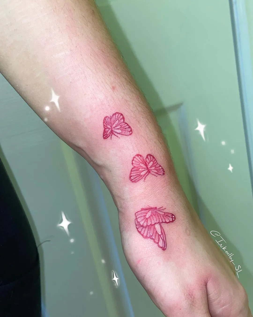 A client showing off the tattoos they received from Inked by SL.