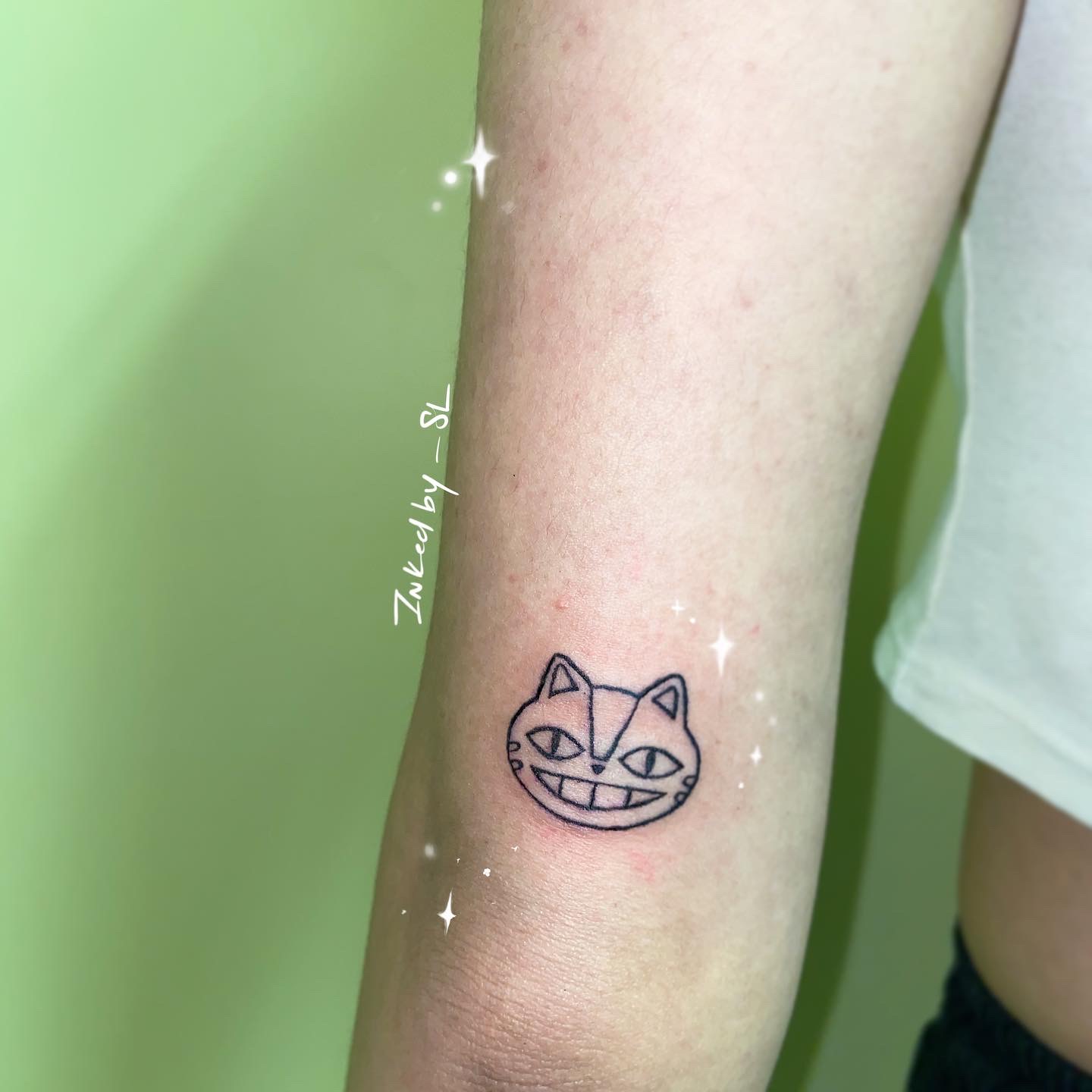 A client showing off the tattoos they received from Inked by SL.