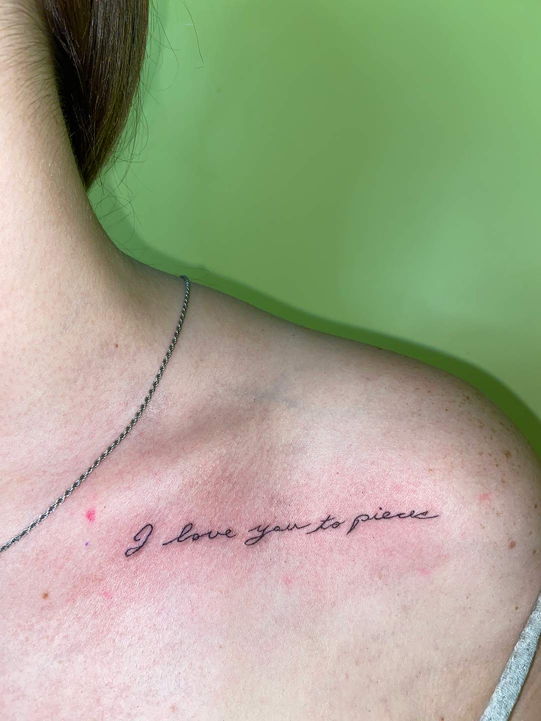 A client showing off the tattoos they received from Inked by SL.