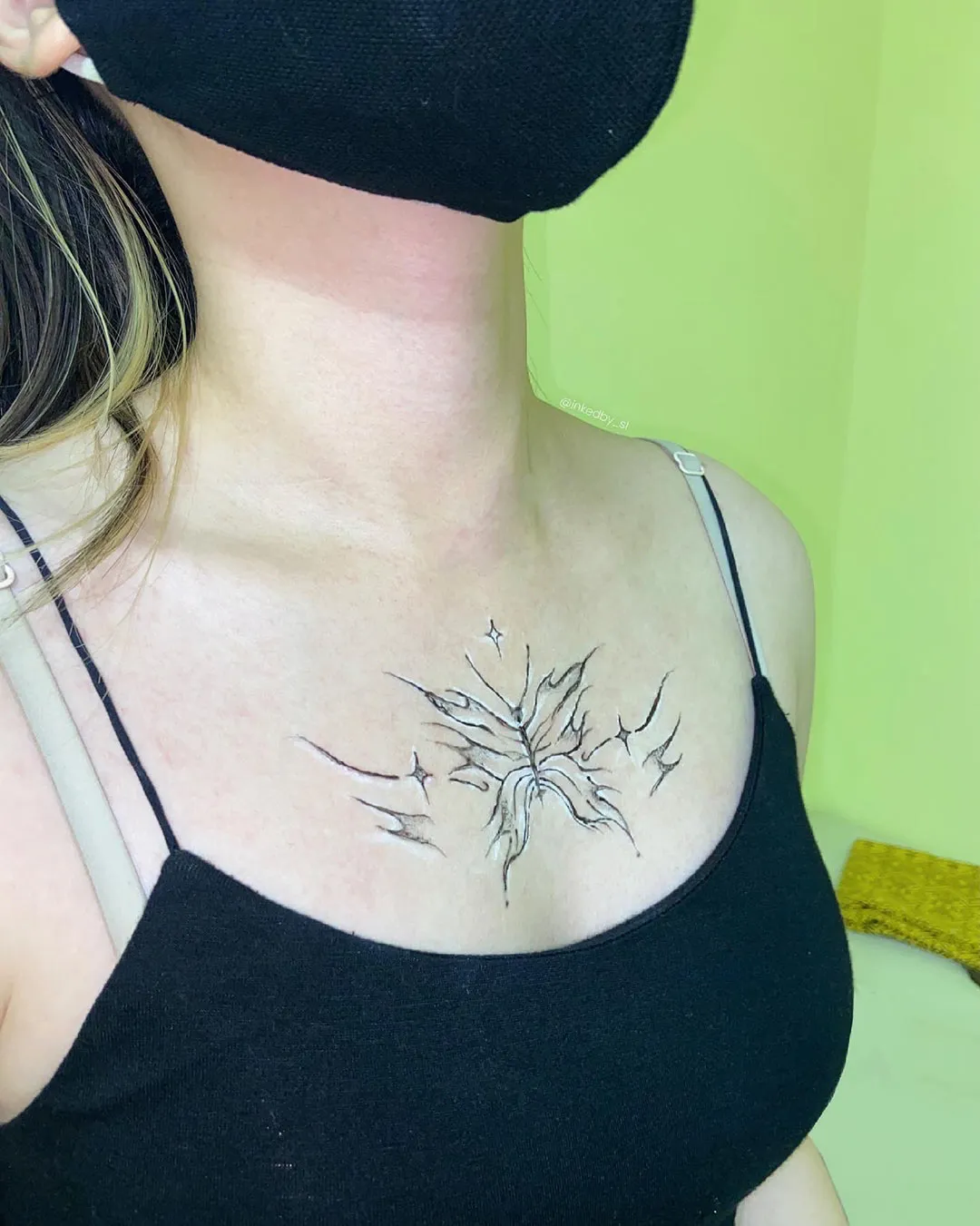 A client showing off the tattoos they received from Inked by SL.