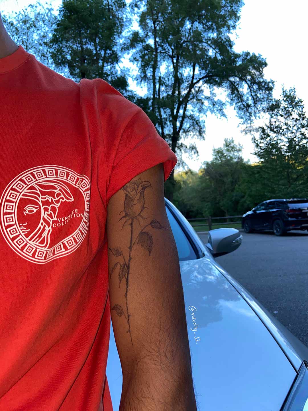 A client showing off the tattoos they received from Inked by SL.