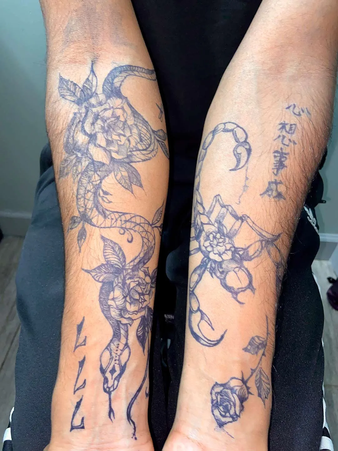 A client showing off the tattoos they received from Inked by SL.