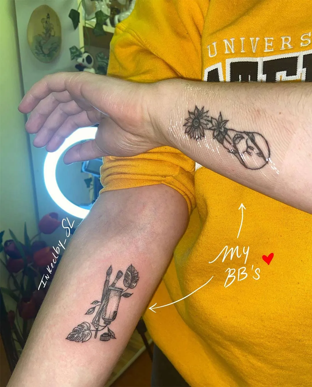 A client showing off the tattoos they received from Inked by SL.