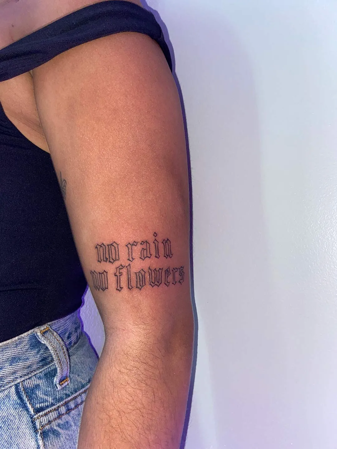 A client showing off the tattoos they received from Inked by SL.