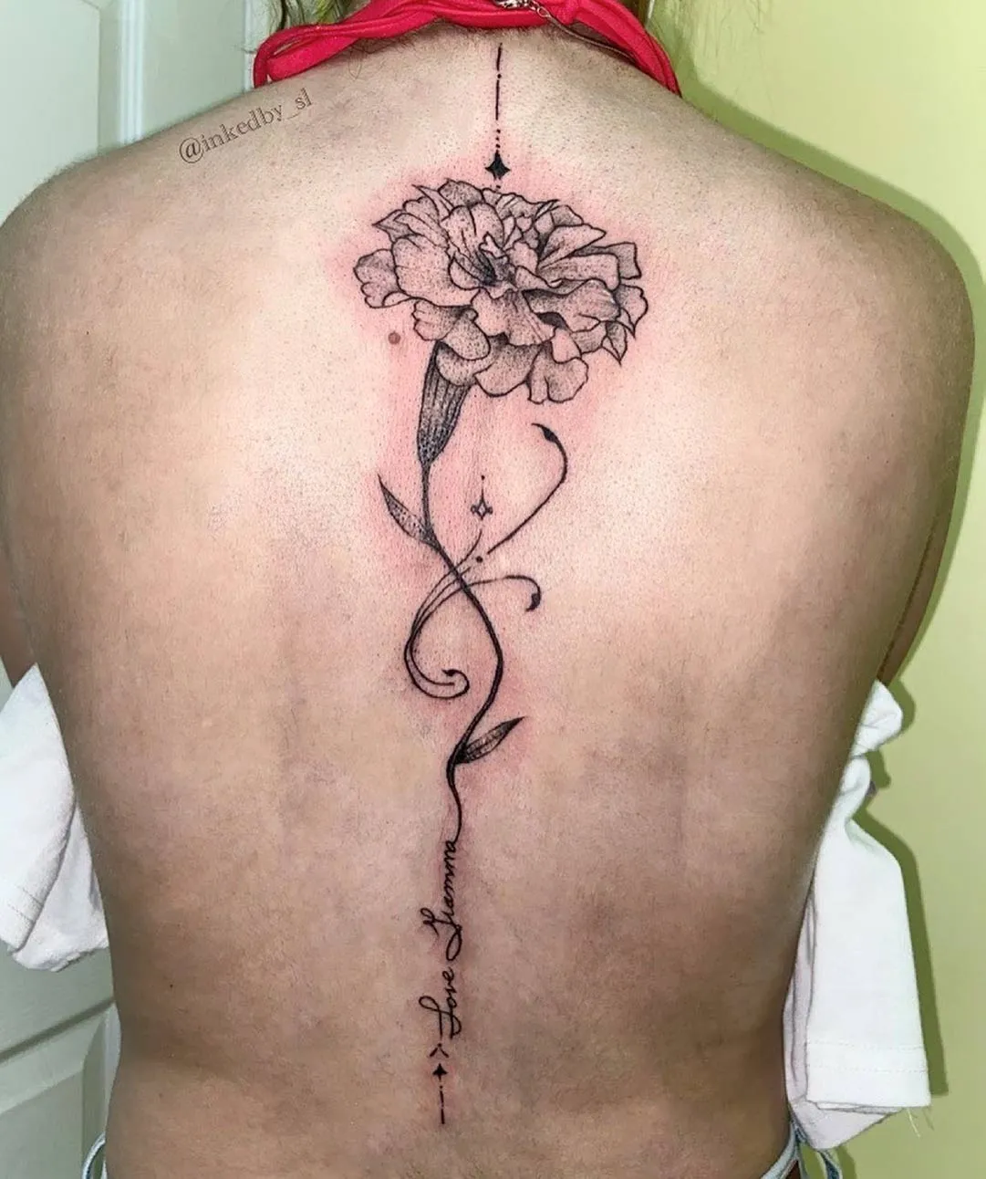 A client showing off the tattoos they received from Inked by SL.