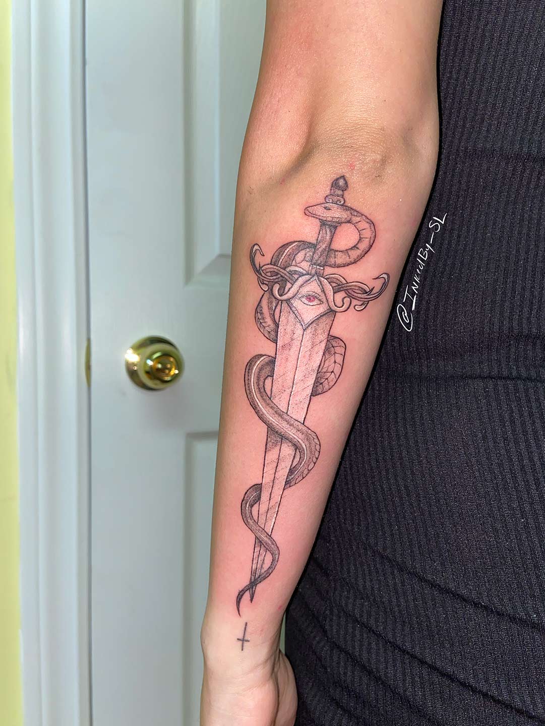 A client showing off the tattoos they received from Inked by SL.