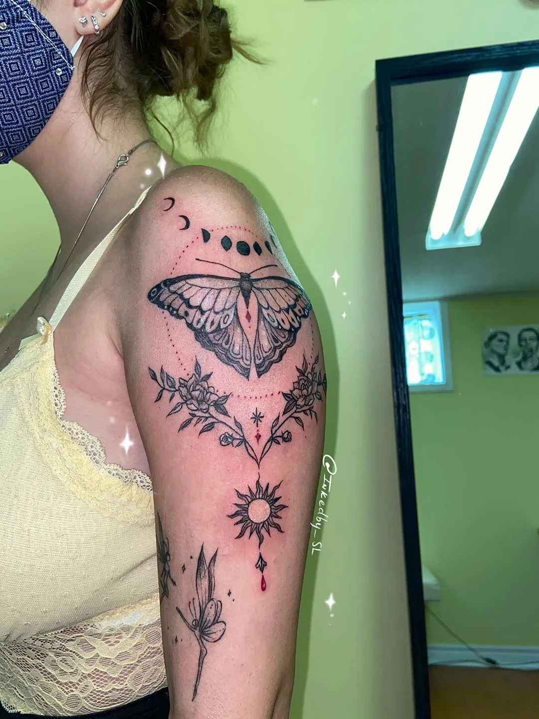 A client showing off the tattoos they received from Inked by SL.