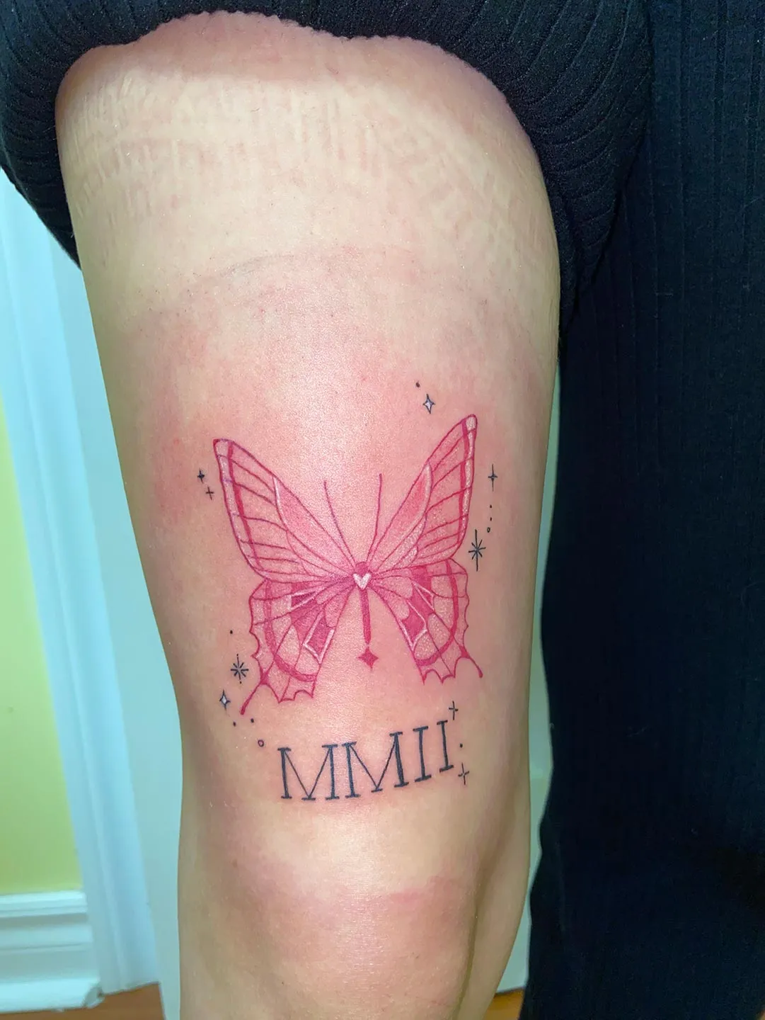 A client showing off the tattoos they received from Inked by SL.