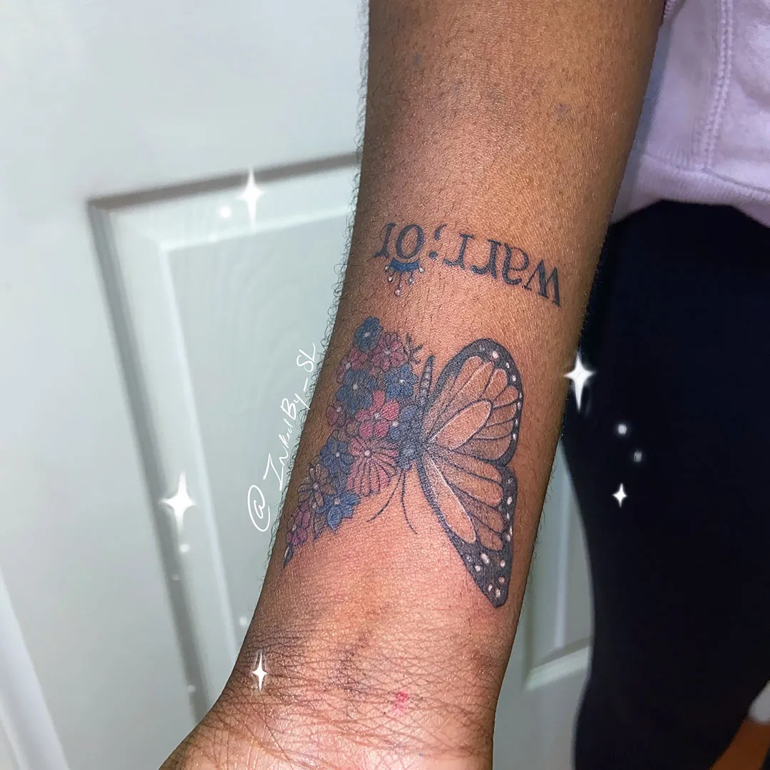 A client showing off the tattoos they received from Inked by SL.