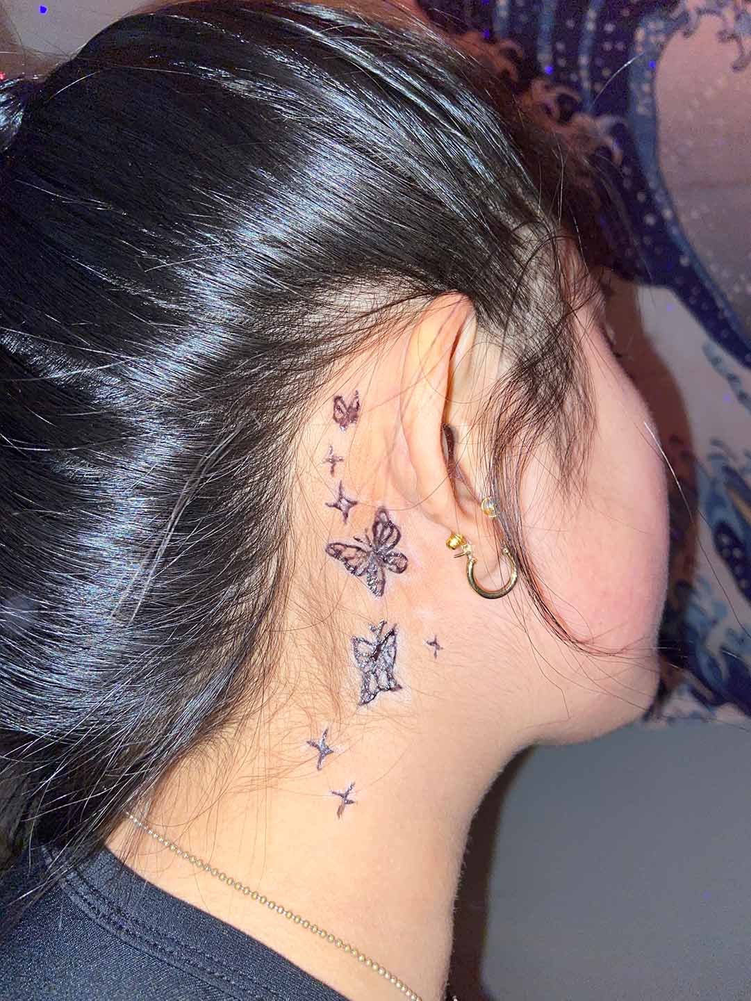 A client showing off the tattoos they received from Inked by SL.