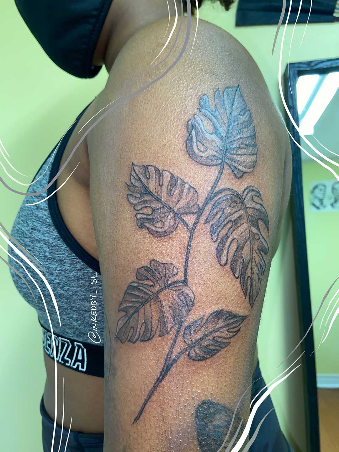 A client showing off the tattoos they received from Inked by SL.