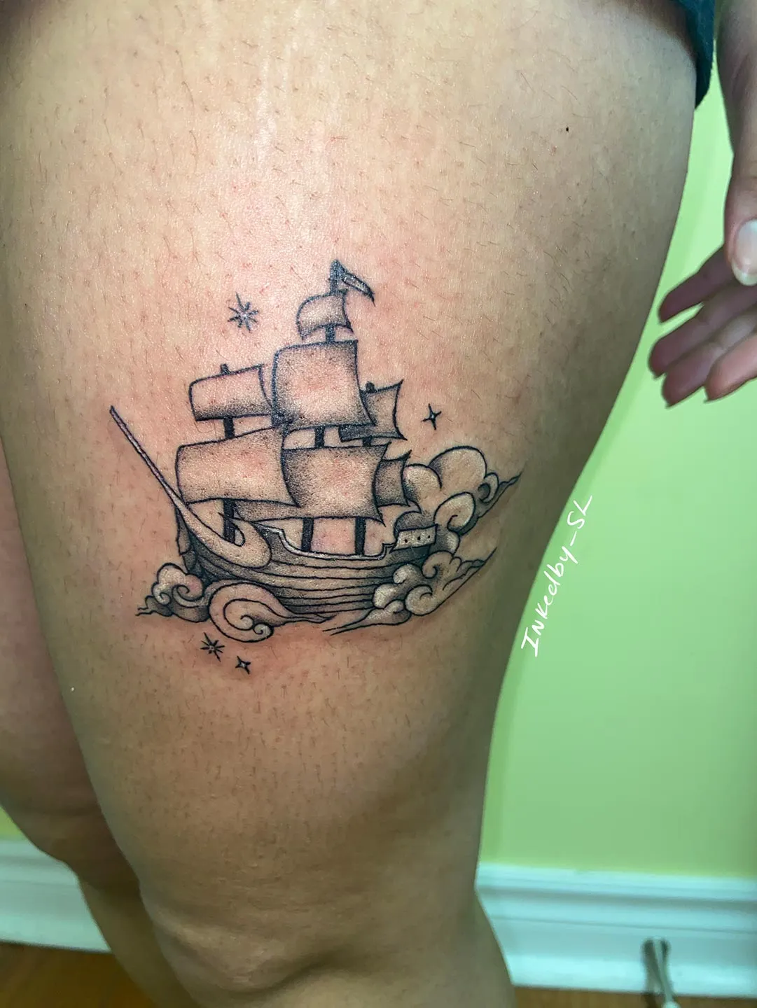 A client showing off the tattoos they received from Inked by SL.