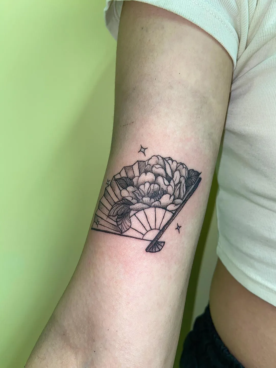 A client showing off the tattoos they received from Inked by SL.