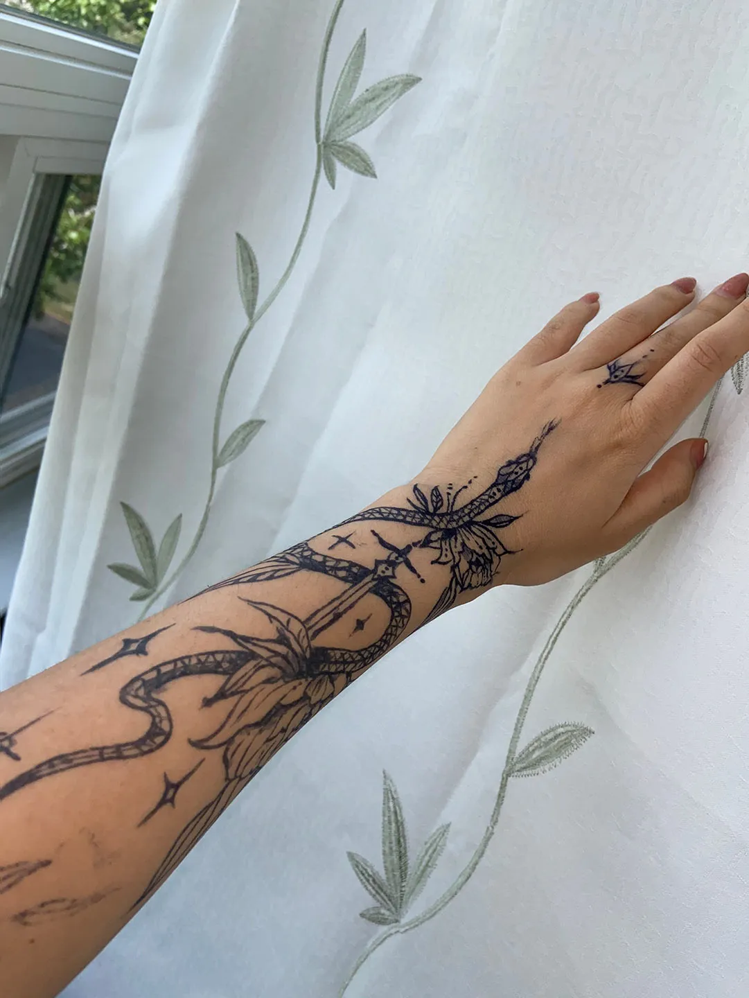 A client showing off the tattoos they received from Inked by SL.