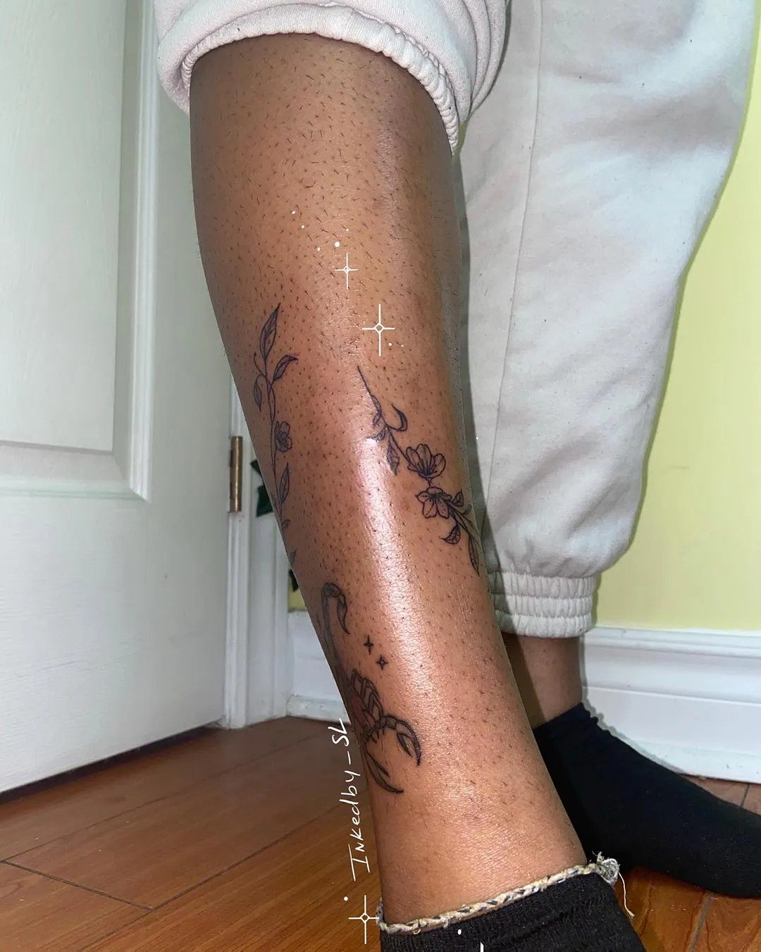 A client showing off the tattoos they received from Inked by SL.