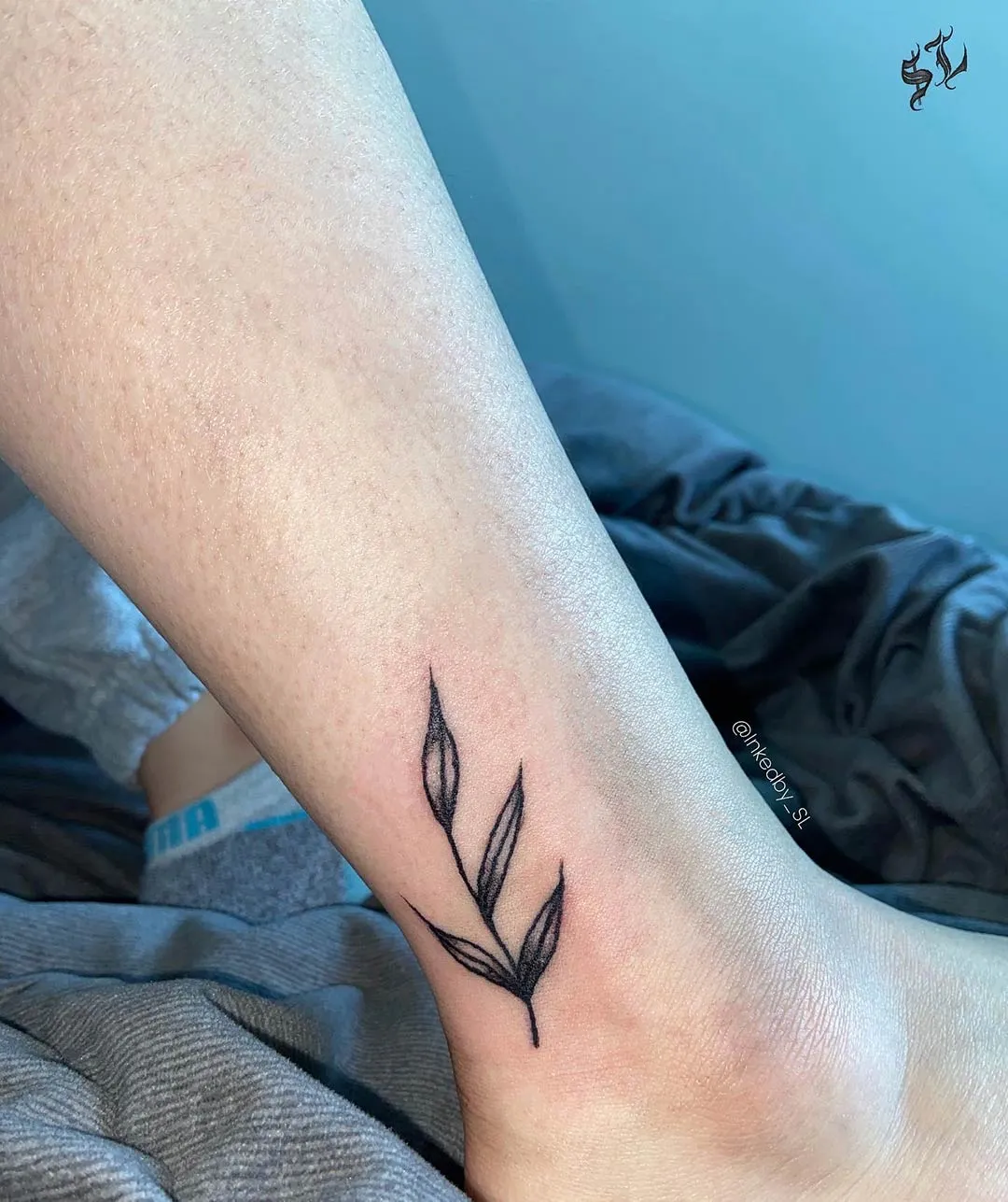 A client showing off the tattoos they received from Inked by SL.