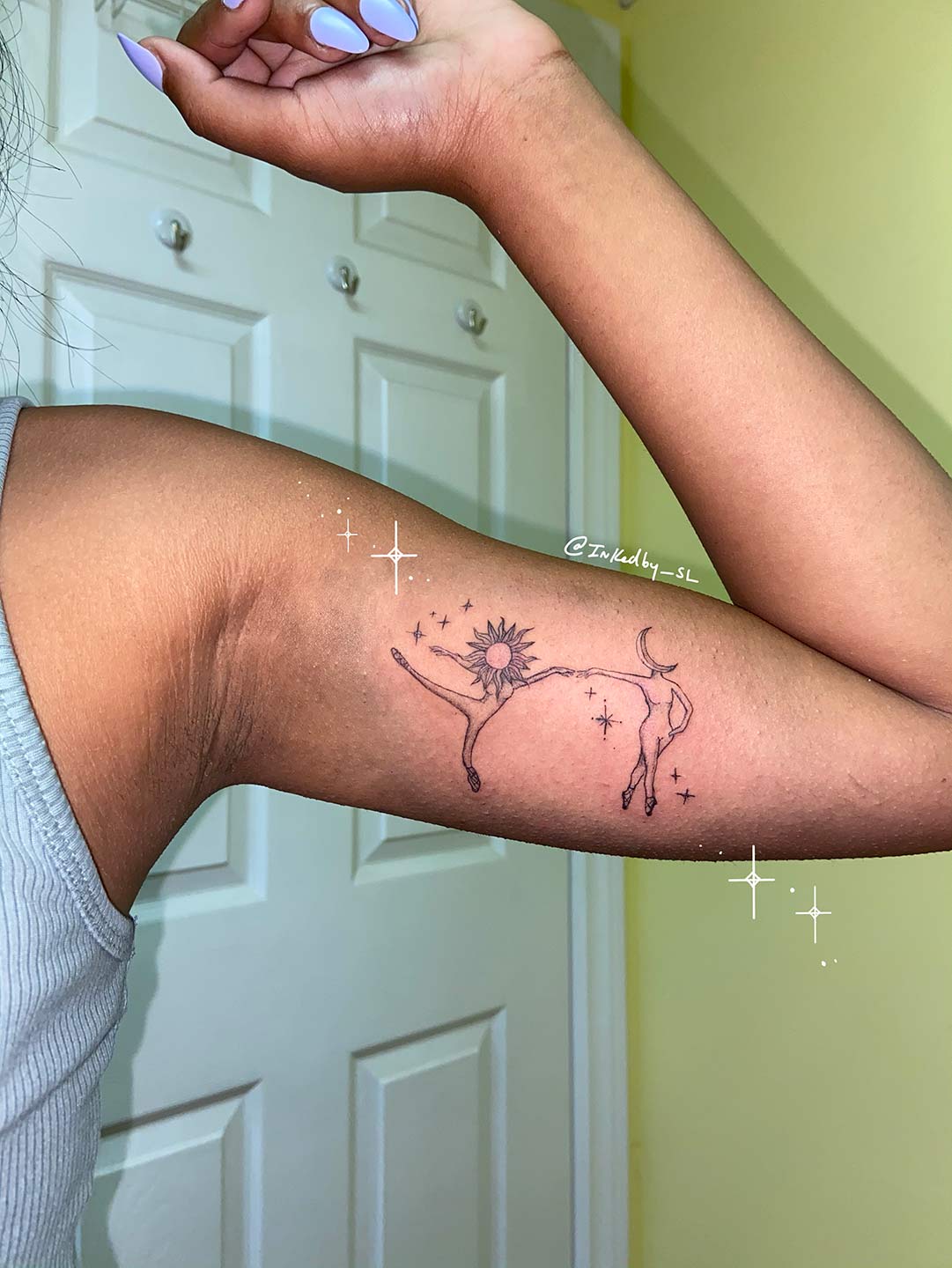 A client showing off the tattoos they received from Inked by SL.