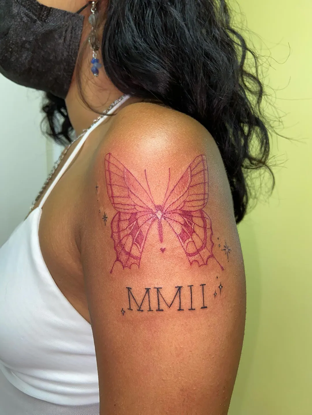 A client showing off the tattoos they received from Inked by SL.