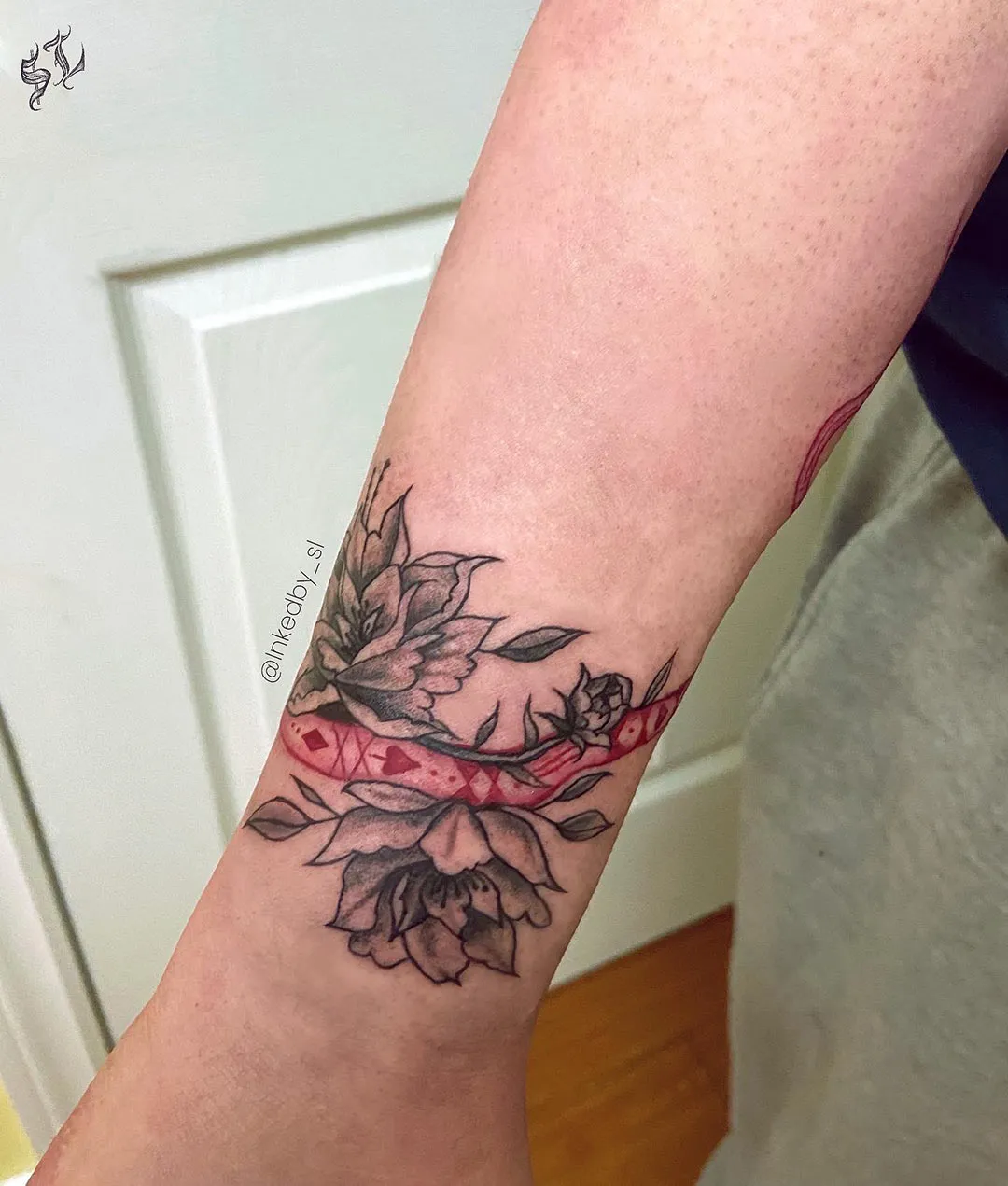 A client showing off the tattoos they received from Inked by SL.