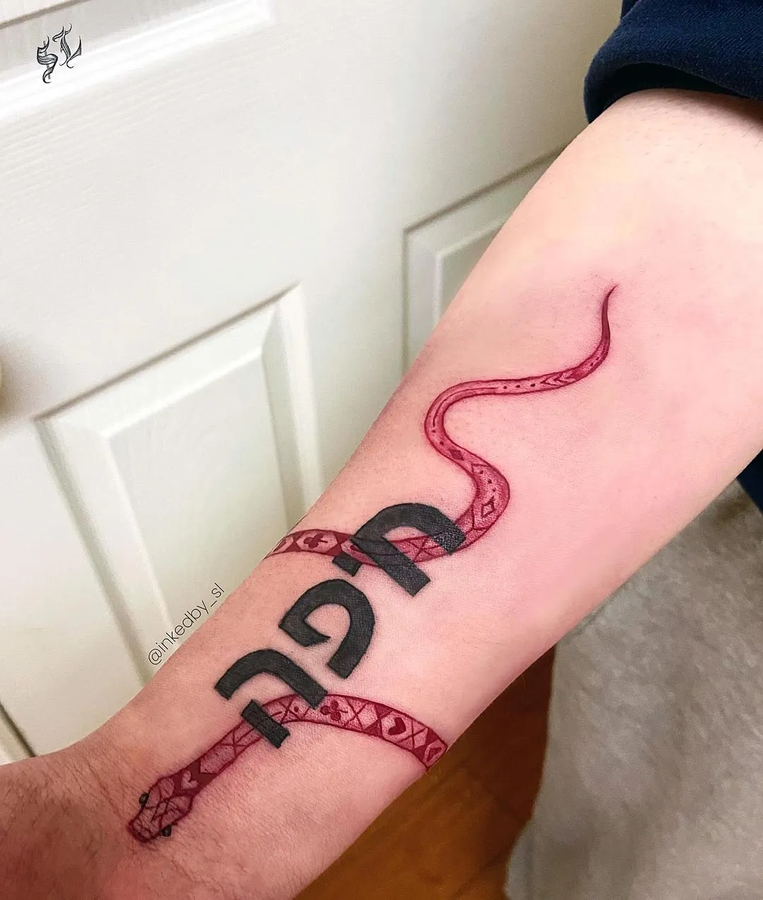 A client showing off the tattoos they received from Inked by SL.