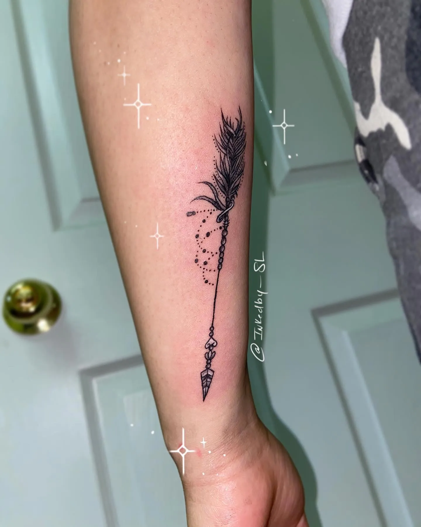 A client showing off the tattoos they received from Inked by SL.