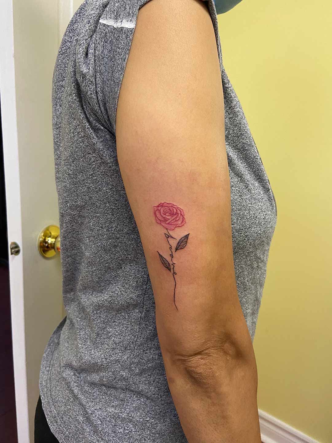 A client showing off the tattoos they received from Inked by SL.