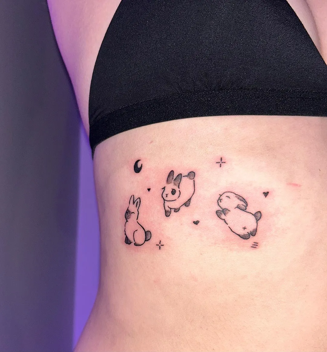 A client showing off the tattoos they received from Inked by SL.