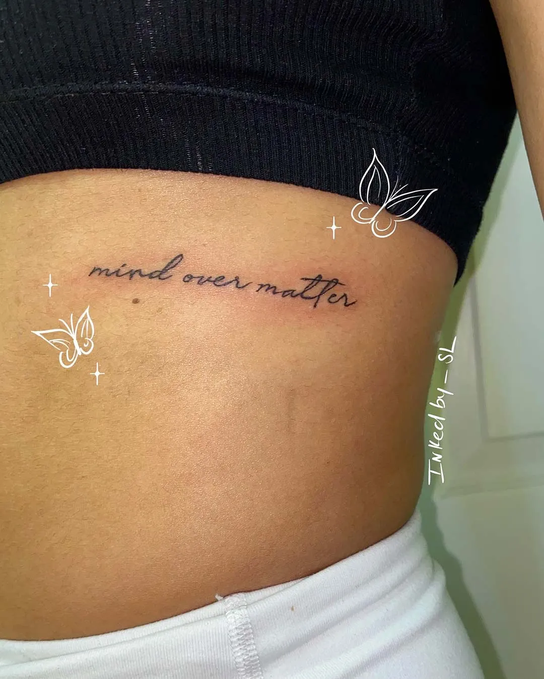 A client showing off the tattoos they received from Inked by SL.