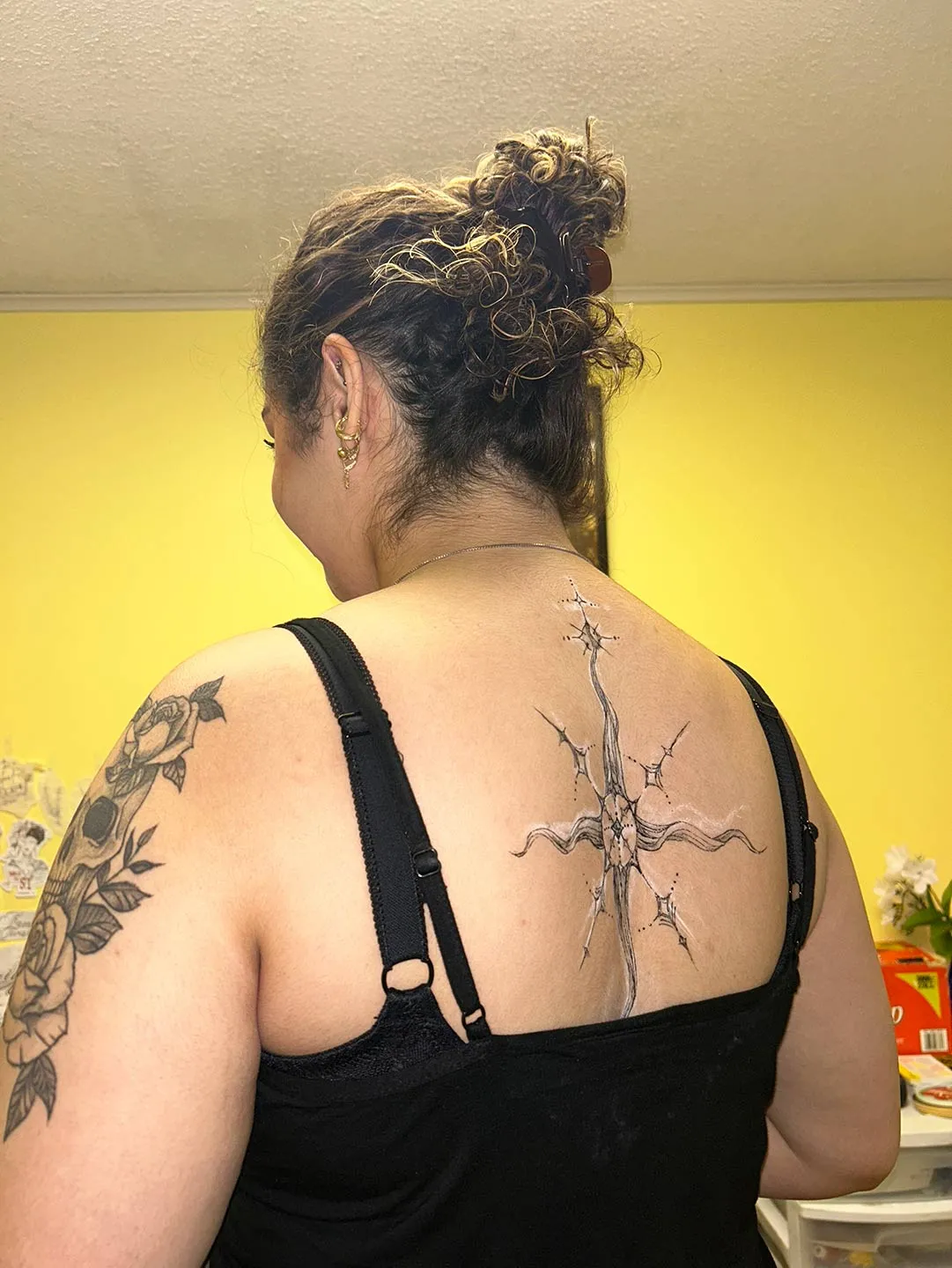 A client showing off the tattoos they received from Inked by SL.