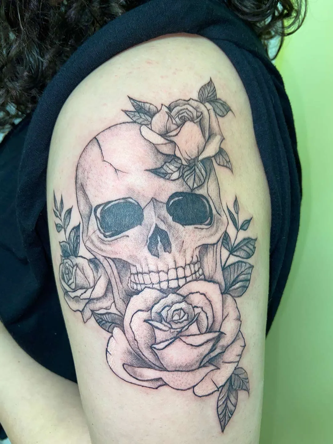 A client showing off the tattoos they received from Inked by SL.