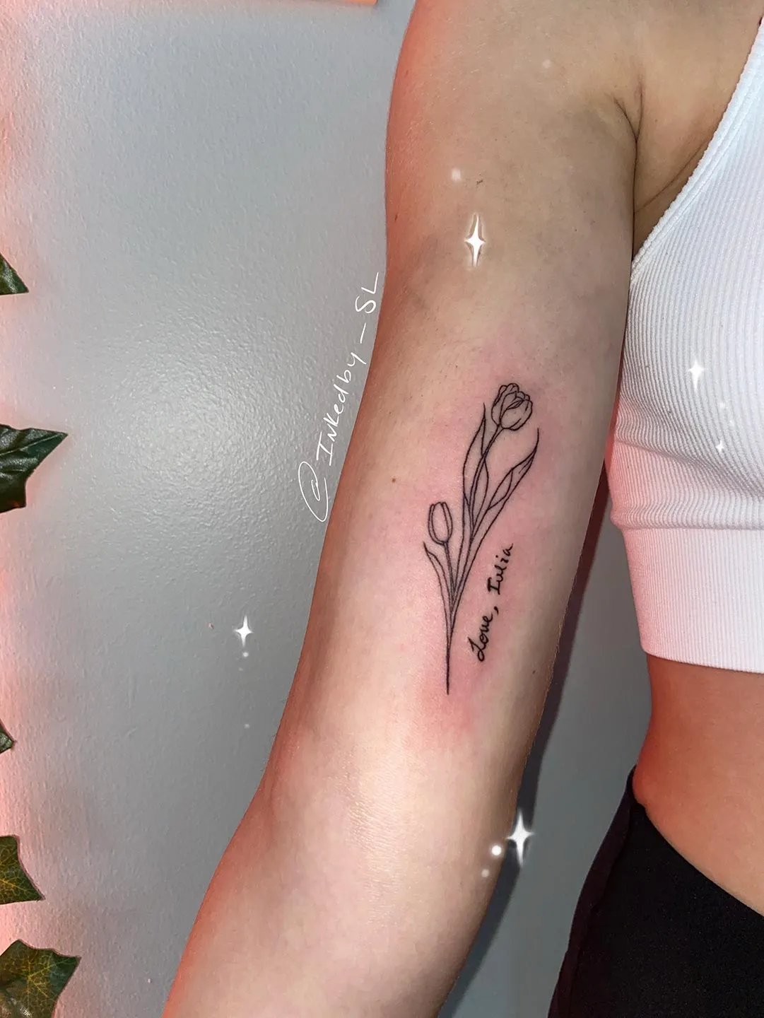 A client showing off the tattoos they received from Inked by SL.